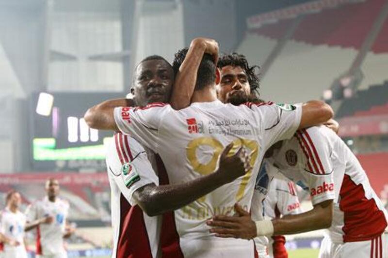 Man-of-the-match Ricardo Oliveira is mobbed by his jubilant teammates at the Mohammed bin Zayed Stadium on Saturday night.