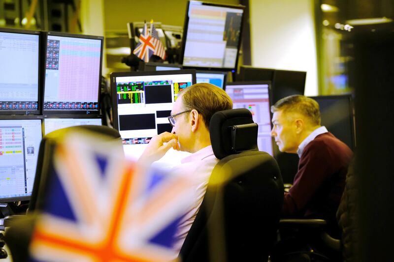 A trader monitors financial data on computer screens as he works on the trading floor at ETX Capital, a broker of contracts-for-difference, after the U.K. general election, in London, U.K. on Friday, Dec. 13, 2019. The pound soared, gilts fell and British stocks surged after Prime Minister Boris Johnson’s Conservative Party won a majority in the U.K. general election, raising hopes that an end to the Brexit deadlock will unlock pent-up investment flows. Photographer: Bryn Colton/Bloomberg