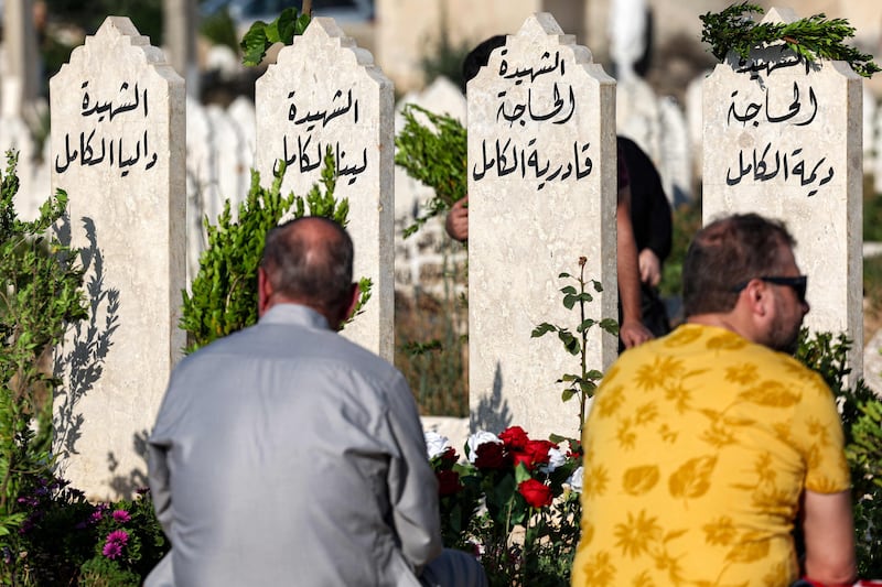 People visit the graves of loved ones on the first day of Eid Al Adha in Syria's rebel-held north-western city of Idlib. AFP