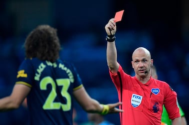 Referee Anthony Taylor (R) shows a red card to Arsenal's Brazilian defender David Luiz (L) during the English Premier League football match between Manchester City and Arsenal at the Etihad Stadium in Manchester, north west England, on June 17, 2020. The Premier League makes its eagerly anticipated return today after 100 days in lockdown but behind closed doors due to coronavirus restrictions. - RESTRICTED TO EDITORIAL USE. No use with unauthorized audio, video, data, fixture lists, club/league logos or 'live' services. Online in-match use limited to 120 images. An additional 40 images may be used in extra time. No video emulation. Social media in-match use limited to 120 images. An additional 40 images may be used in extra time. No use in betting publications, games or single club/league/player publications. / AFP / POOL / PETER POWELL / RESTRICTED TO EDITORIAL USE. No use with unauthorized audio, video, data, fixture lists, club/league logos or 'live' services. Online in-match use limited to 120 images. An additional 40 images may be used in extra time. No video emulation. Social media in-match use limited to 120 images. An additional 40 images may be used in extra time. No use in betting publications, games or single club/league/player publications.