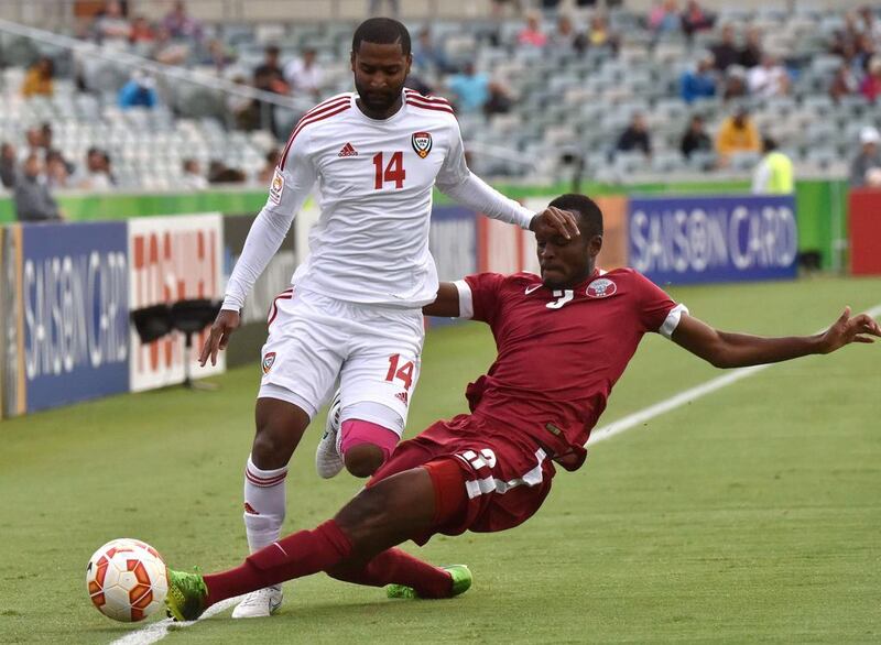 Abdelaziz Sanqour of the UAE fights for the ball with Abdelkarim Hassan of Qatar during the Group C Asian Cup football match between UAE and Qatar in Canberra on January 11, 2015. AFP 