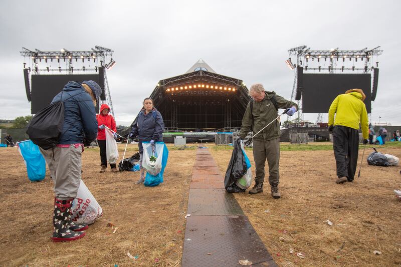 Volunteers began shifting rubbish strewn across the 324-hectare site, as revellers made their way home after the festival on Monday morning. EPA 