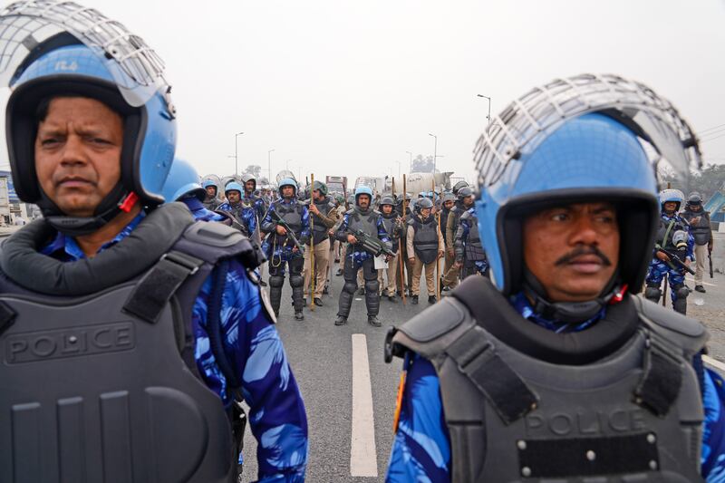 Security guards prevent thousands of protesting farmers marching from northern Haryana and Punjab states from entering the Indian capital Delhi. AP
