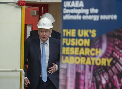 Britain's Prime Minister Boris Johnson gestures during his visit to the Fusion Energy Research Centre at the Fulham Science Centre in Oxfordshire, south east England on August 8, 2019. (Photo by Julian SIMMONDS / POOL / AFP) / EMBARGOED TO 1800 - AUGUST 8, 2019.