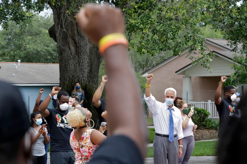 US Representative Charlie Crist, second from right, stands in solidarity with guests during a Juneteenth 2020 celebration in Florida. AP Photo