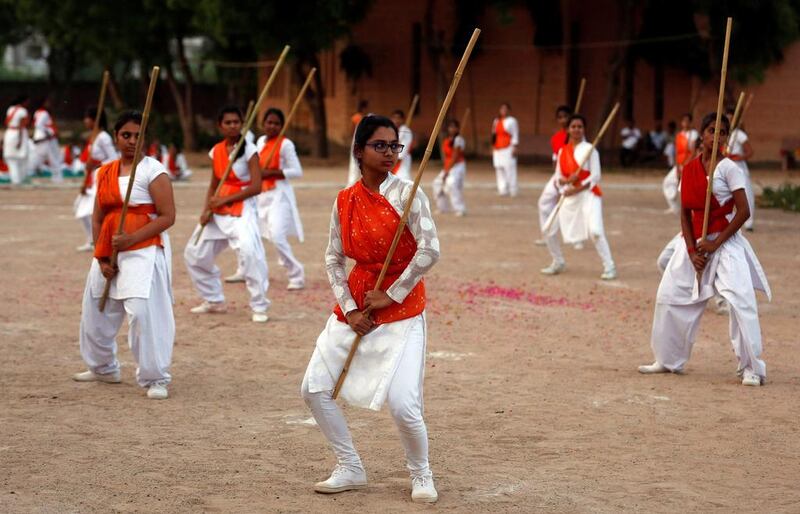 Members of Durga Vahini, the women's wing of hardline Vishwa Hindu Parishad, show their self-defence skills at the concluding ceremony of a weeklong women's training camp on the outskirts of Ahmedabad.  Amit Dave / Reuters