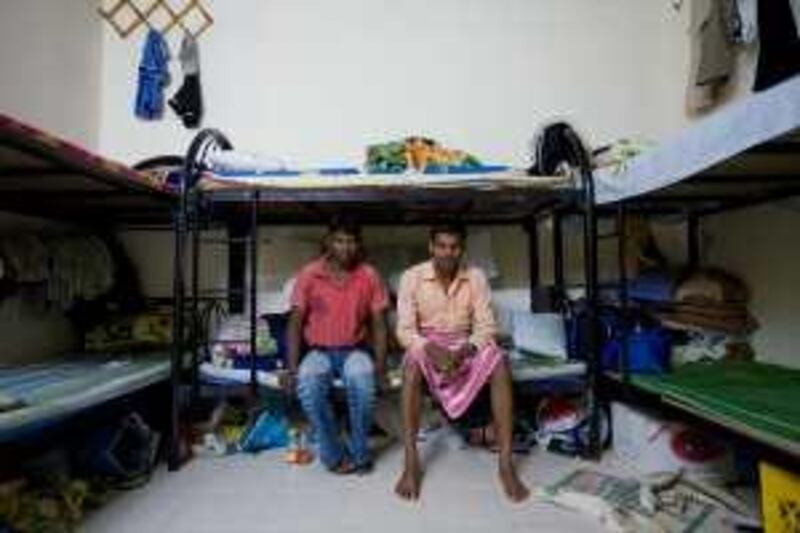 United Arab Emirates - Semeih - Jan 20 - 2010 : Two labour workers pose for a portrait in the room they share with other six workers in a labour camp for Indians and Bangladesh workers. They haven't receive their payment in 4 or 5 months. They are carpenters and were working in Saadiyat Island.( Jaime Puebla / The National ) *** Local Caption ***  JP labour camps 02.jpg