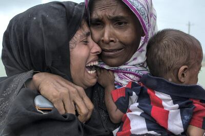 DAKHINPARA, BANGLADESH - SEPTEMBER 08:  Rohingya Muslim refugees react after being re-united with each other after arriving on a boat from Myanmar on September 08, 2017 in Whaikhyang Bangladesh. Thousands of Rohingya continue to cross the border after violence erupted in Myanmar's Rakhine state when the country's security forces allegedly launched an operation against the Rohingya Muslim community.  (Photo by Dan Kitwood/Getty Images)