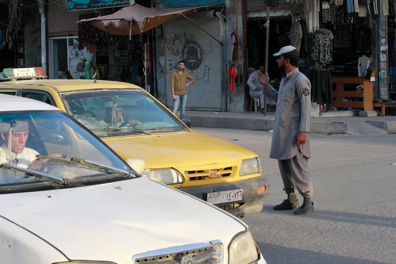 An ISIS policeman controls traffic in the city in September 2014.
