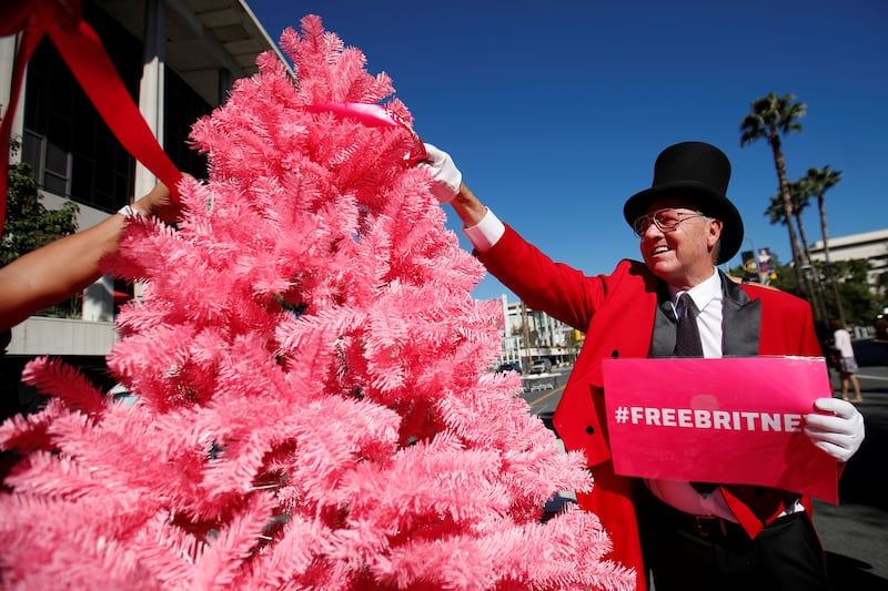 Supporters decorate a pink Christmas tree outside the courthouse. Reuters