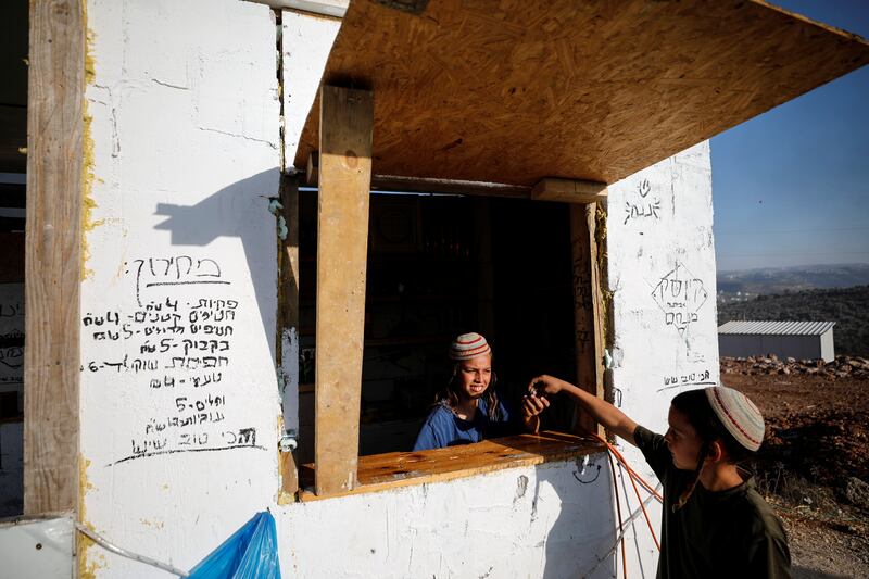 Jewish settler children play in a provisonary kiosk at Eviatar.