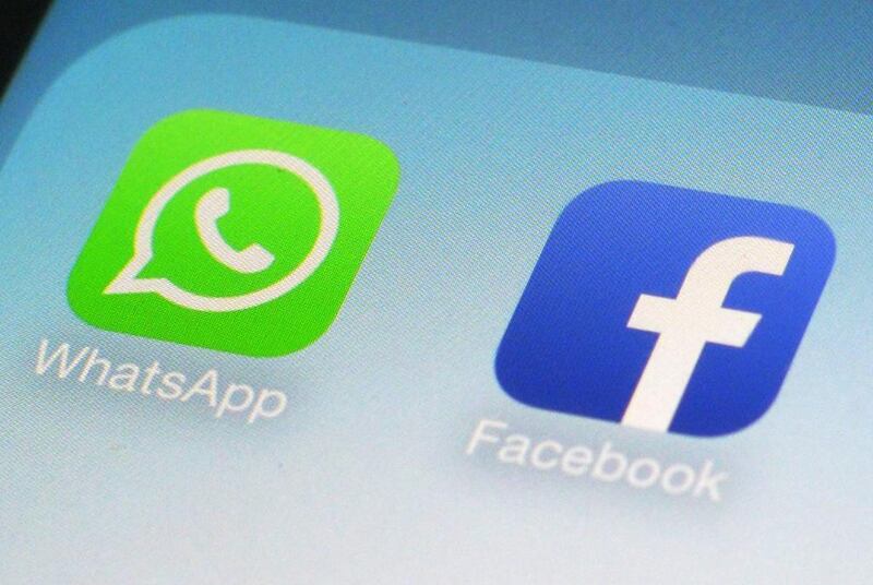 WhatsApp and Facebook app icons on a smartphone. Facebook has been ordered to stop taking German users' data. Patrick Sison / AP
