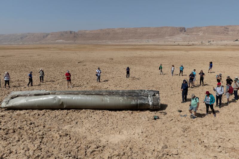 The wreckage of an intercepted ballistic missile that fell near the Dead Sea in Israel draws a crowd. AP Photo