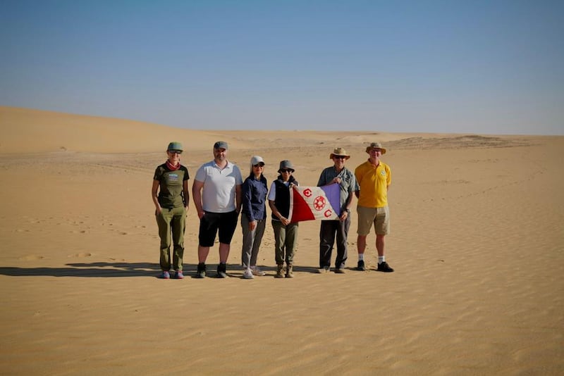 The Heart of Arabia team with the flag of the Explorers Club of New York