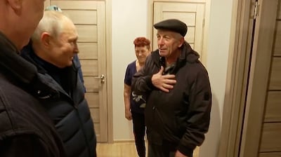 Russian President Vladimir Putin with residents at their new flat during his visit to Mariupol. AP 