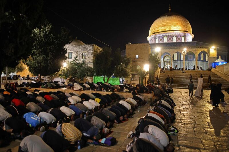 Palestinian worshippers prostrate in pursuit of Laylat Al Qadr outside the Dome of the Rock in Jerusalem's Al Aqsa Mosque compound. AFP