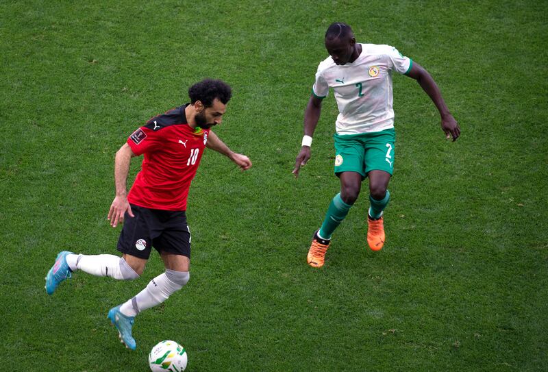 Egypt's Mohamed Salah under pressure from Saliou Ciss of Senegal. AP