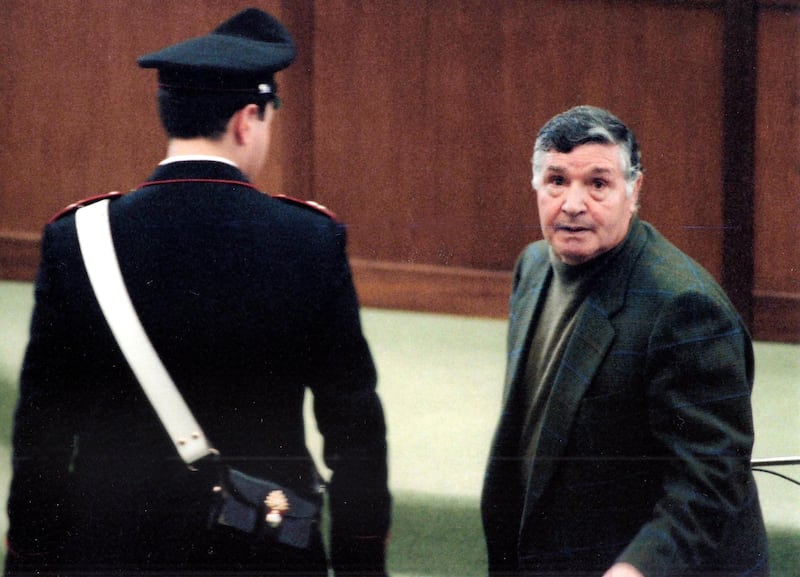 A picture taken on March 8, 1993 shows mafia boss Salvatore "Toto" Riina during his trial at the high security prison Ucciardone in Palermo. Former "boss of bosses" Toto Riina, one of the most feared Godfathers in the history of the Sicilian Mafia, died early on November 17, 2017 after battling cancer, according to Italian media reports. 
Riina, 87, who had been serving 26 life sentences and is thought to have ordered more than 150 murders, had been in a coma and his family had been given permission by Italy's health ministry Thursday for a rare visit to say goodbye. / AFP PHOTO / Alessandro FUCARINI