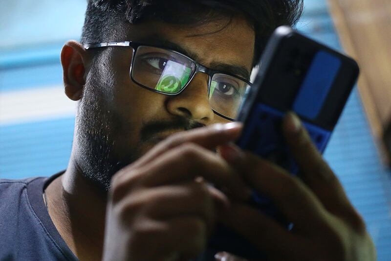 A WhatsApp user in Karachi, Pakistan, checks his phone after major social media services go down. EPA