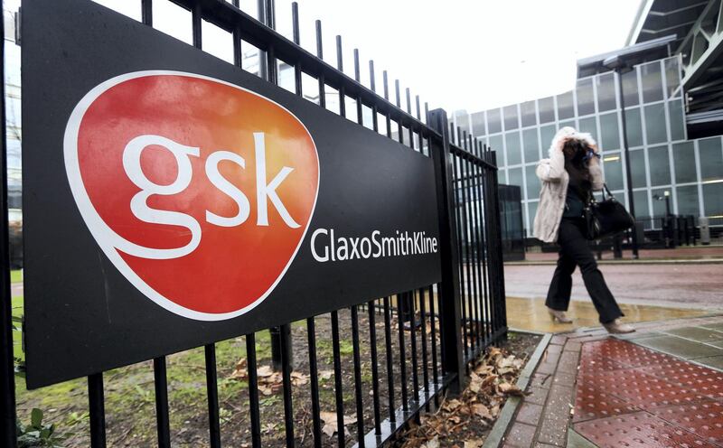A visitor leaves GlaxoSmithKline Plc's headquarters in London, U.K., on Wednesday, Feb. 5, 2014. GlaxoSmithKline, the U.K.'s biggest drugmaker, forecast that revenue will rise by about 2 percent this year as it introduces new medicines. Photographer: Chris Ratcliffe/Bloomberg