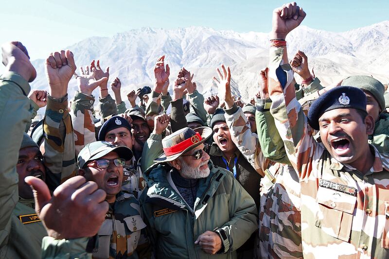 Mr Modi cheers with troops stationed in Kargil in the far north of India.