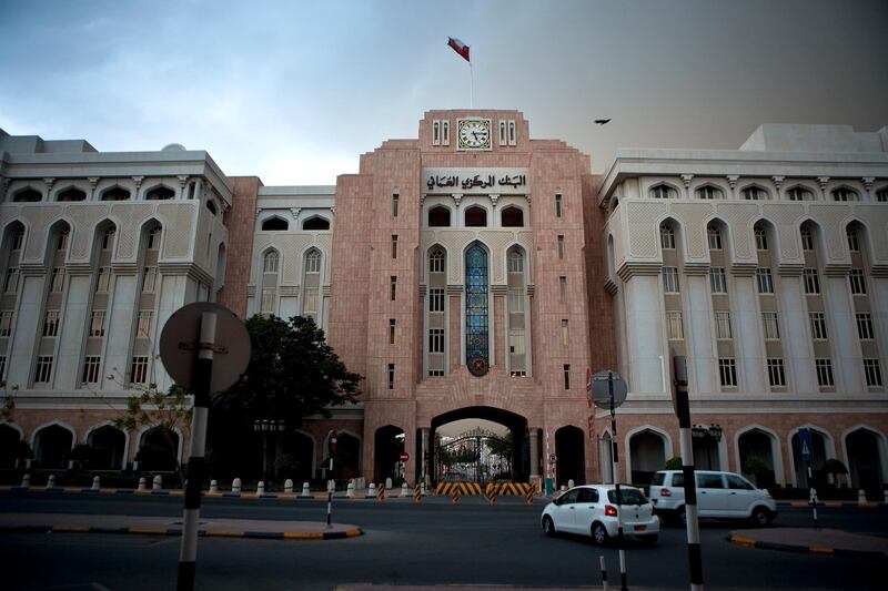 Passing in front of the Central Bank of Oman building, a couple of lone cars brave a common sand storm and a rare rain shower that momentarily halted evening rush hour on Wednesday evening, Oct. 12, 2011, in the Commercial Muttrah Business District in Ruwi, Muscat, the capital of the Sultanate of Oman. (Silvia Razgova / The National)

