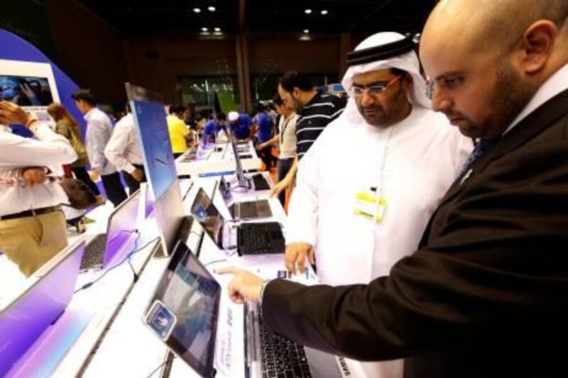 Dubai, United Arab Emirates- April, 03, 2013: Visitors  browses the latest Laptops at the Samsung store during the Gitex Shoppers-2013 at the Dubai World Trade Centre in Dubai .  (  Satish Kumar / The National ) For Business