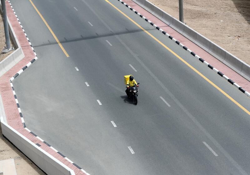 Dubai, United Arab Emirates - Reporter: N/A: Corona. A car scooter drives off Sheikh Zayed Road during the 24hr lockdown due to Covid-19. Tuesday, April 14th, 2020. Dubai. Chris Whiteoak / The National