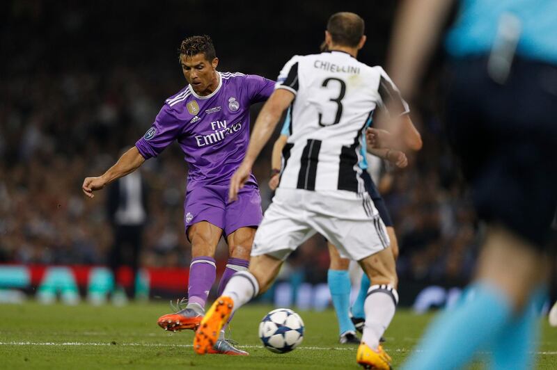 Real Madrid's Portuguese striker Cristiano Ronaldo shoots and scores during the UEFA Champions League final football match between Juventus and Real Madrid at The Principality Stadium in Cardiff, south Wales, on June 3, 2017. (Photo by Adrian DENNIS / AFP)