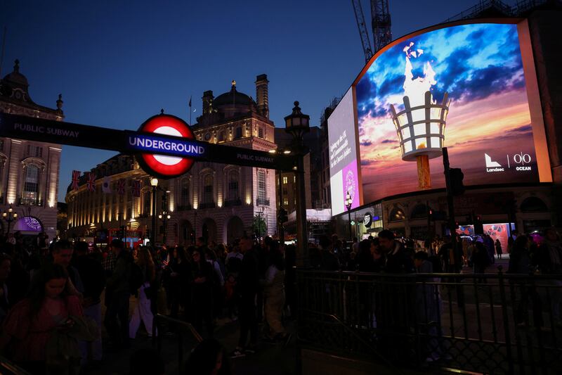 People view a virtual beacon onscreen during Queen Elizabeth II's platinum jubilee celebrations at Picadilly Circus in London, Britain June 2, 2022. Reuters