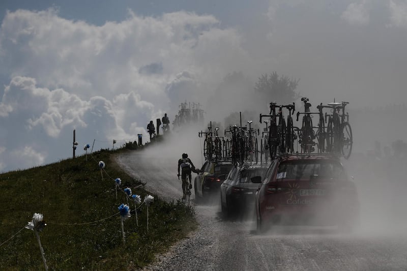 France's Fabien Grellier rides by his team's manager car in the ascent of Plateau des Glieres during the 10th stage of the Tour de France between Annecy and Le Grand-Bornand. Jeff Pachoud / AFP