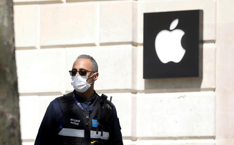 FILE PHOTO: A municipal policeman wearing a protective face mask walks past the closed Apple store on the Champs-Elysees avenue in Paris as a lockdown is imposed to slow the rate of the coronavirus disease (COVID-19) in France, April 16, 2020. REUTERS/Charles Platiau/File Photo