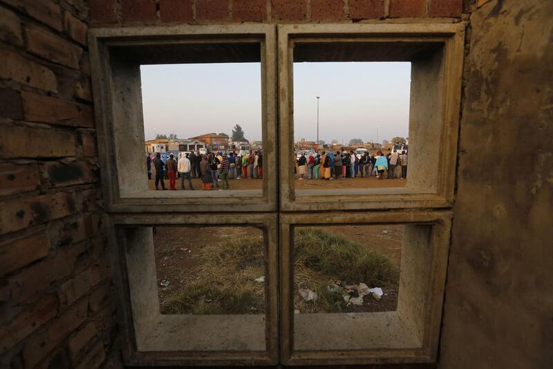 Some of the hundreds of people stand in line to cast their vote at a polling station in Bekkersdal, Johannesburg, South Africa, 07 May 2014. South Africans started voting in general elections expected to keep the ruling African National Congress in power, even if polls said it could lose votes over corruption and enduring poverty. About 25 million people were eligible to vote in the elections. Kim Ludbrook / EPA