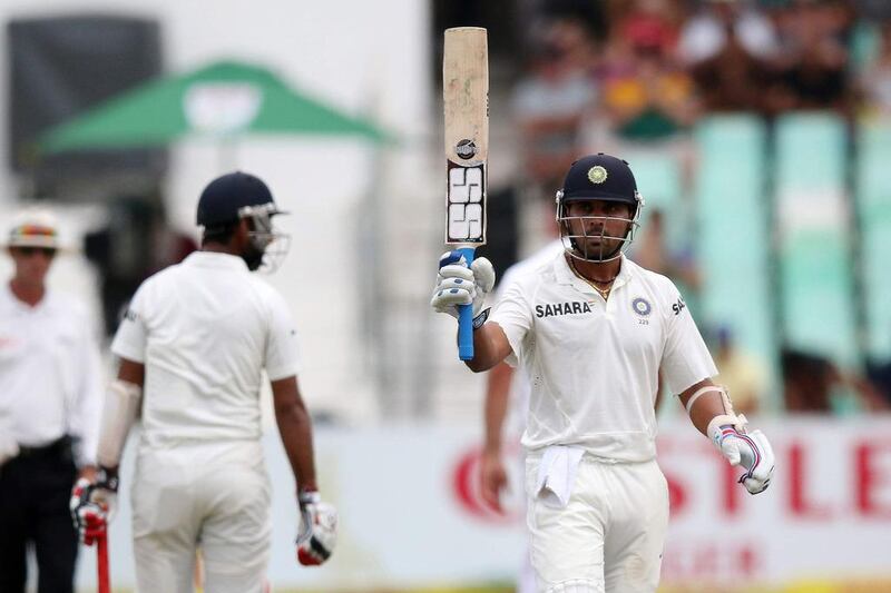 Murali Vijay celebrates his half century on Thursday. Anesh Debiky / AFP