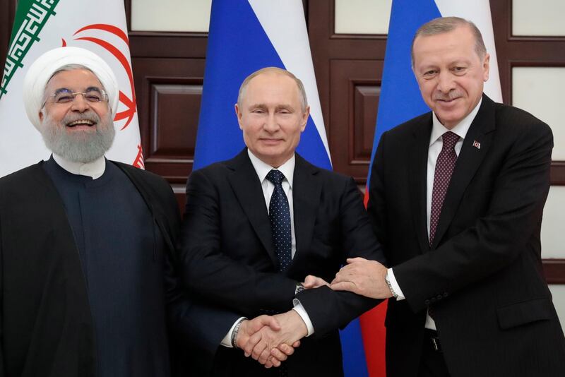 epaselect epa07369696 (L-R) Iranian President Hassan Rouhani, Russian President Vladimir Putin and Turkish President Recep Tayyip Erdogan shake hands during their meeting in the Black sea resort of Sochi, Russia, 14 February 2019. The leaders of Russia, Turkey and Iran hold their fourth trilateral meeting to discuss further joint steps with a view to a long-term peace settlement in Syria.  EPA/SERGEI CHIRIKOV / POOL