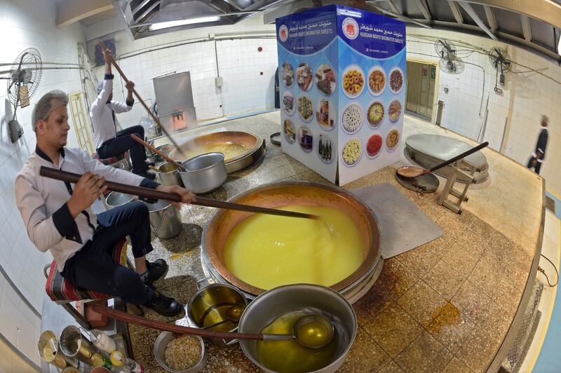 Workers prepare Halwa, a Bahraini sweet made primarily from sugar, corn starch, saffron and nuts at Hussain Showaiter Sweets at the Muharraq island store in northern Bahrain.