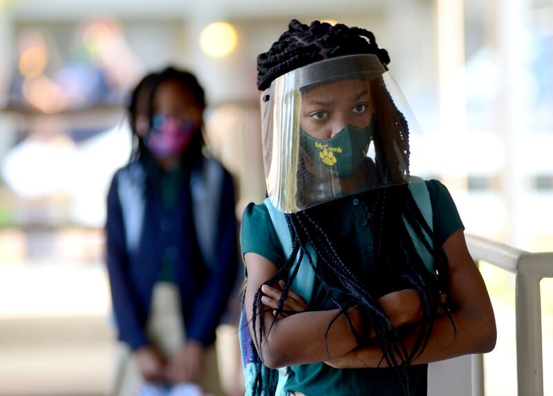Victoria Dickens wears a mask and face shield as she waits for her class assignment at Summit Elementary School in Summit, Mississippi on August 5, 2021, during the first day of the 2021-22 school year. AP
