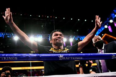 (FILES) This file photo taken on August 21, 2021 shows Manny Pacquiao of the Philippines waving and bowing at the crowd after losing against Yordenis Ugas of Cuba following the WBA Welterweight Championship boxing match at T-Mobile Arena in Las Vegas, Nevada.  - Philippine boxing legend and 2022 presidential hopeful Manny Pacquiao said on September 29, 2021 that he is hanging up his gloves after a glittering decades-long career in the ring.  (Photo by Patrick T.  FALLON  /  AFP)
