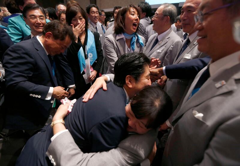 Prime Minister Shinzo Abe of Japan (C) celebrates with members of the Tokyo bid committee after Jacques Rogge, president of the International Olympic Committee (IOC), announced Tokyo as the city to host the 2020 Summer Olympic Games during a ceremony in Buenos Aires September 7, 2013. REUTERS/Marcos Brindicci (ARGENTINA - Tags: SPORT OLYMPICS POLITICS) *** Local Caption ***  BAS378_OLYMPICS-202_0907_11.JPG