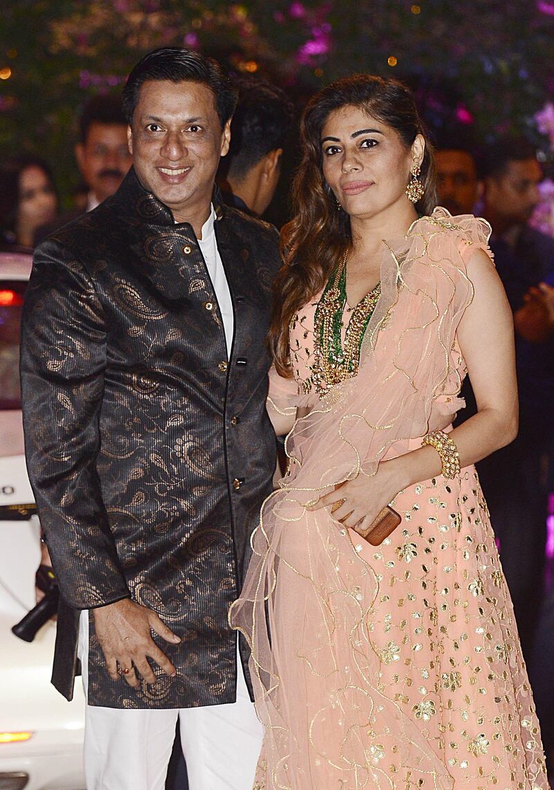 Indian Bollywood film director and producer Madhur Bhandarka poses for a picture with his wife as they attend the engagement party of India's richest man and Reliance Industries Limited Chairman, Mukesh Ambani’s eldest son Akash Ambani and fiancee Shloka Mehta, in Mumbai late on June 30, 2018. AFP