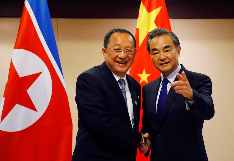 North Korean Foreign Minister Ri Yong Ho, left, is greeted by his Chinese counterpart Wang Yi prior to their bilateral meeting in the sidelines of the 50th ASEAN Foreign Ministers' Meeting and its Dialogue Partners Sunday, Aug. 6, 2017 in suburban Pasay city, south Manila, Philippines. Bolstered by new U.N. sanctions, the United States and North Korea's neighbors are joining in a fresh attempt to isolate Pyongyang over its nuclear and missile programs, in a global campaign cheered on by U.S. President Donald Trump. (AP Photo/Bullit Marquez)