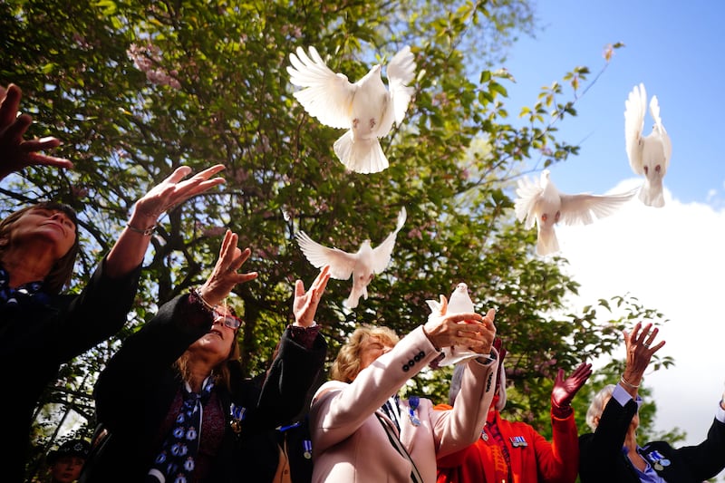 White doves are released in St James's Square. PA