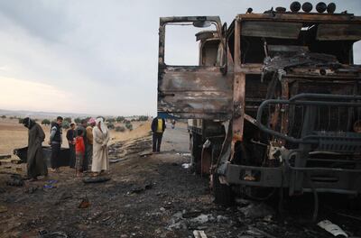 A picture taken on October 27, 2019, shows Syrian locals checking a destroyed truck at the spot where Abu Hassan al-Muhajir, the Islamic State (IS) group's spokesman was reportedly killed in a raid in the northern Syrian village of Ayn al-Bayda near Jarablus.

 The right-hand of Baghdadi and the spokesman for IS, was targeted in a coordinated operation between the Syrian Democratic Forces (SDF) intelligence and the US army, SDF chief Mazloum Abdi said on Twitter. / AFP / Aaref WATAD
