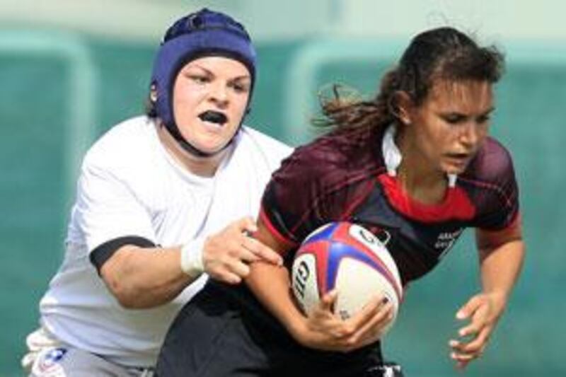 The Arabian Gulf women's rugby team (red and blue ) and USA compete in a warm-up match.