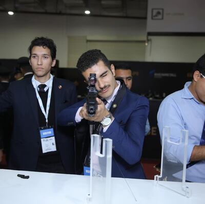 A visitor to Edex 2018 tries out one of the rifles on display. Photo: EDEX