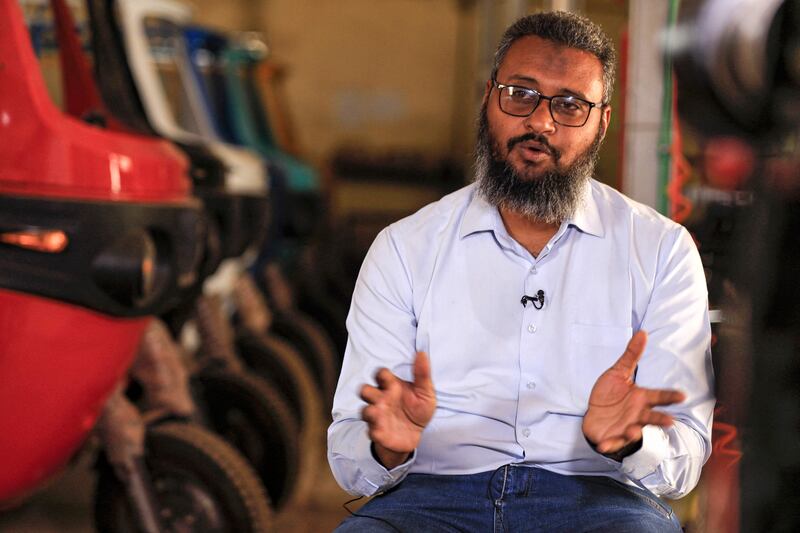 Mohamed Samir, owner of al-Shehab factory, gives an interview at his plant, extolling the virtues of electric tuk-tuks.  