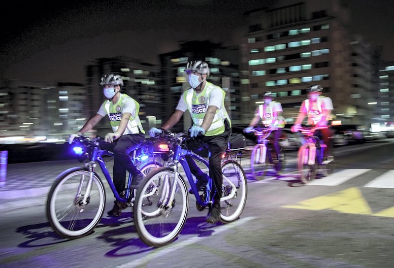 Abu Dhabi, United Arab Emirates, May 11, 2020.   Abu Dhabi Police bicycle patrol do night operations around the Mussaffah area to warn or catch curfew violators in the residential areas. --  Police officers start the nighttime operations.Victor Besa / The NationalSection:  NAReporter:  Haneen Dajani