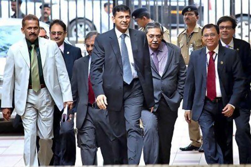 The newly appointed governor of the Reserve Bank of India, Raghuram Rajan, centre, arrives at the RBI head office in Mumbai yesterday. Divyakant Solanki / EPA