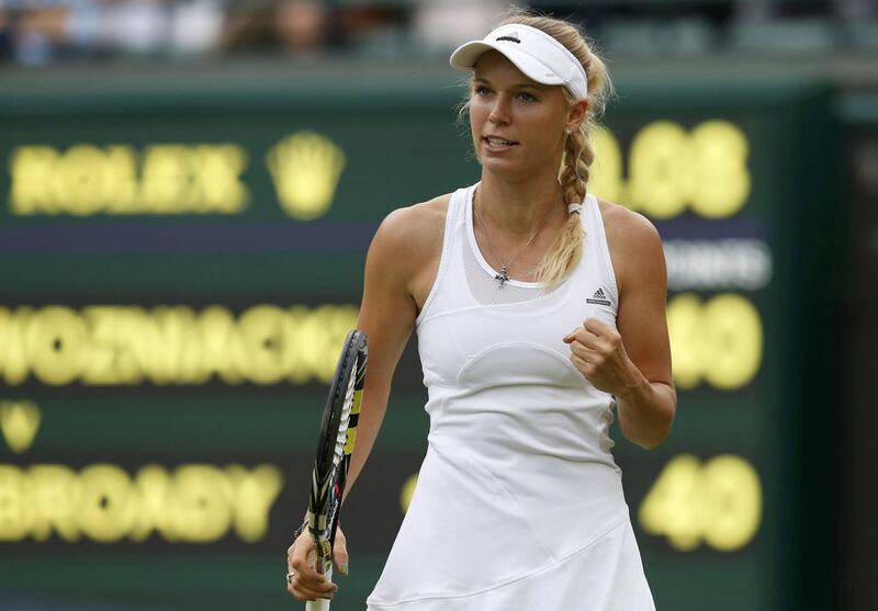 Caroline Wozniacki of Denmark reacts during her women's singles match against Naomi Broady of Britain at the Wimbledon Tennis Championships in London on June 25, 2014.          Suzanne Plunkett / Reuters