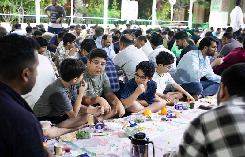 People of all age groups attend iftar at Imam Hussein Mosque in Al Satwa, Dubai.  Leslie Pableo for The National